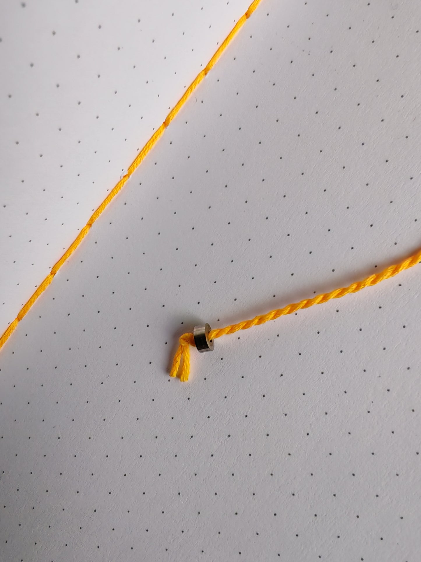 Yellow thread book mark with metal bead