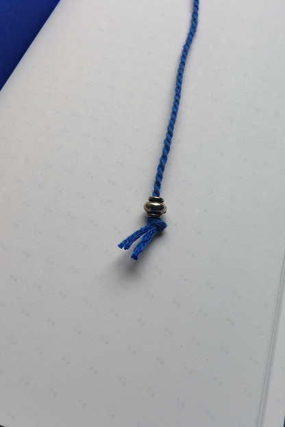 Blue braided cord with a metal bead on a white background