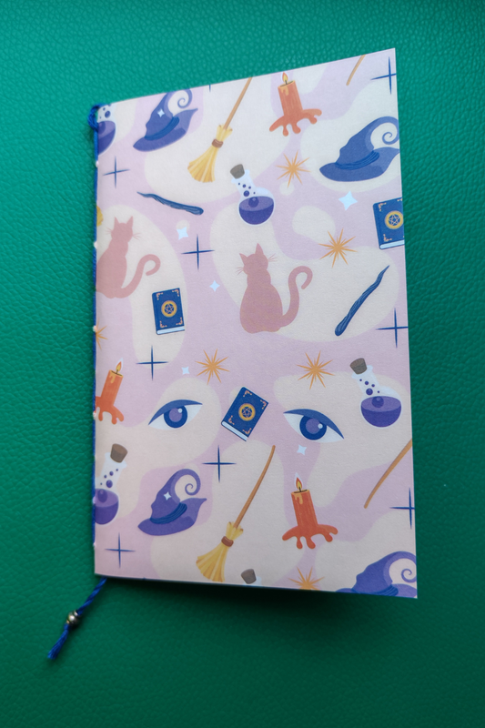 Notebook with a magical theme on a green background