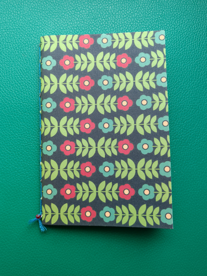 Notebook with floral pattern on a green background