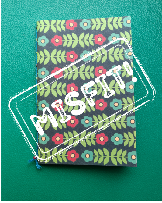Notebook with floral pattern and 'MISPIT' text on a green background