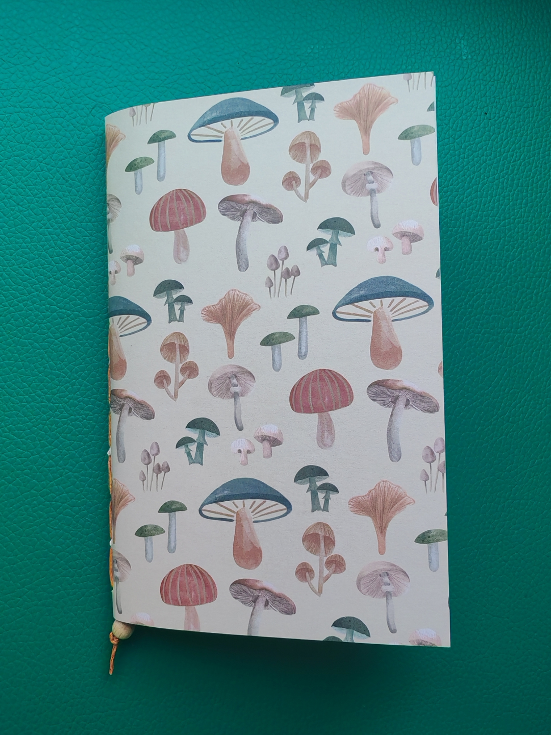 Notebook with mushroom pattern on a green background