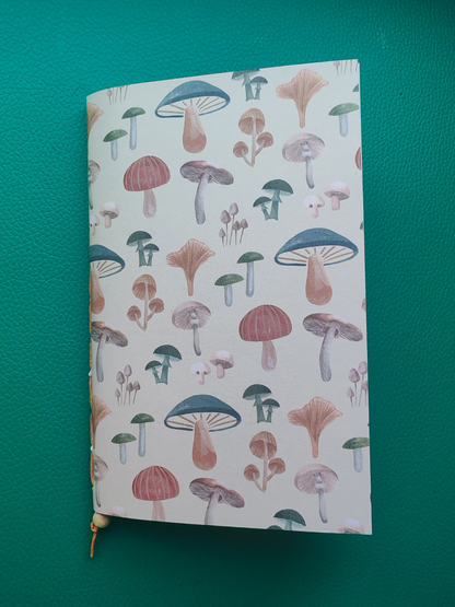 Notebook with mushroom pattern on a green background