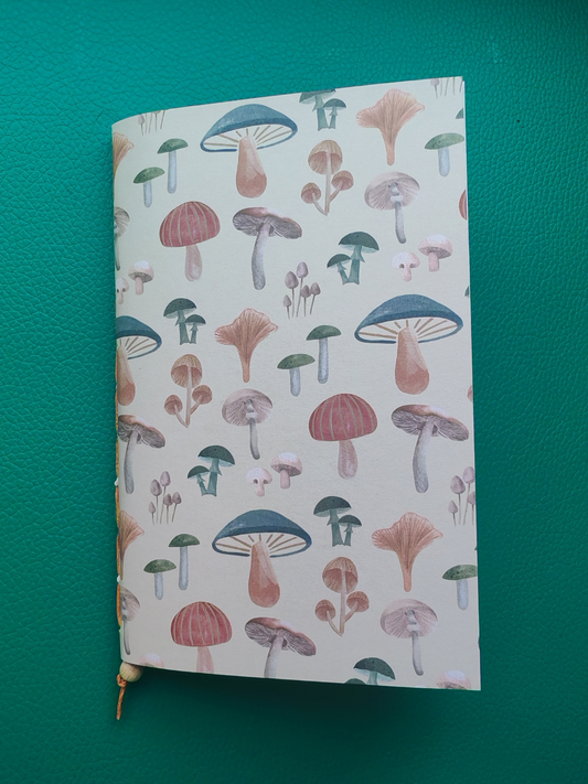 Notebook with mushroom pattern on a green background