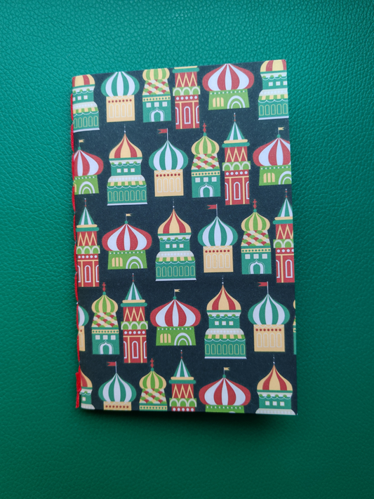 Notebook with colorful architectural design on a green background