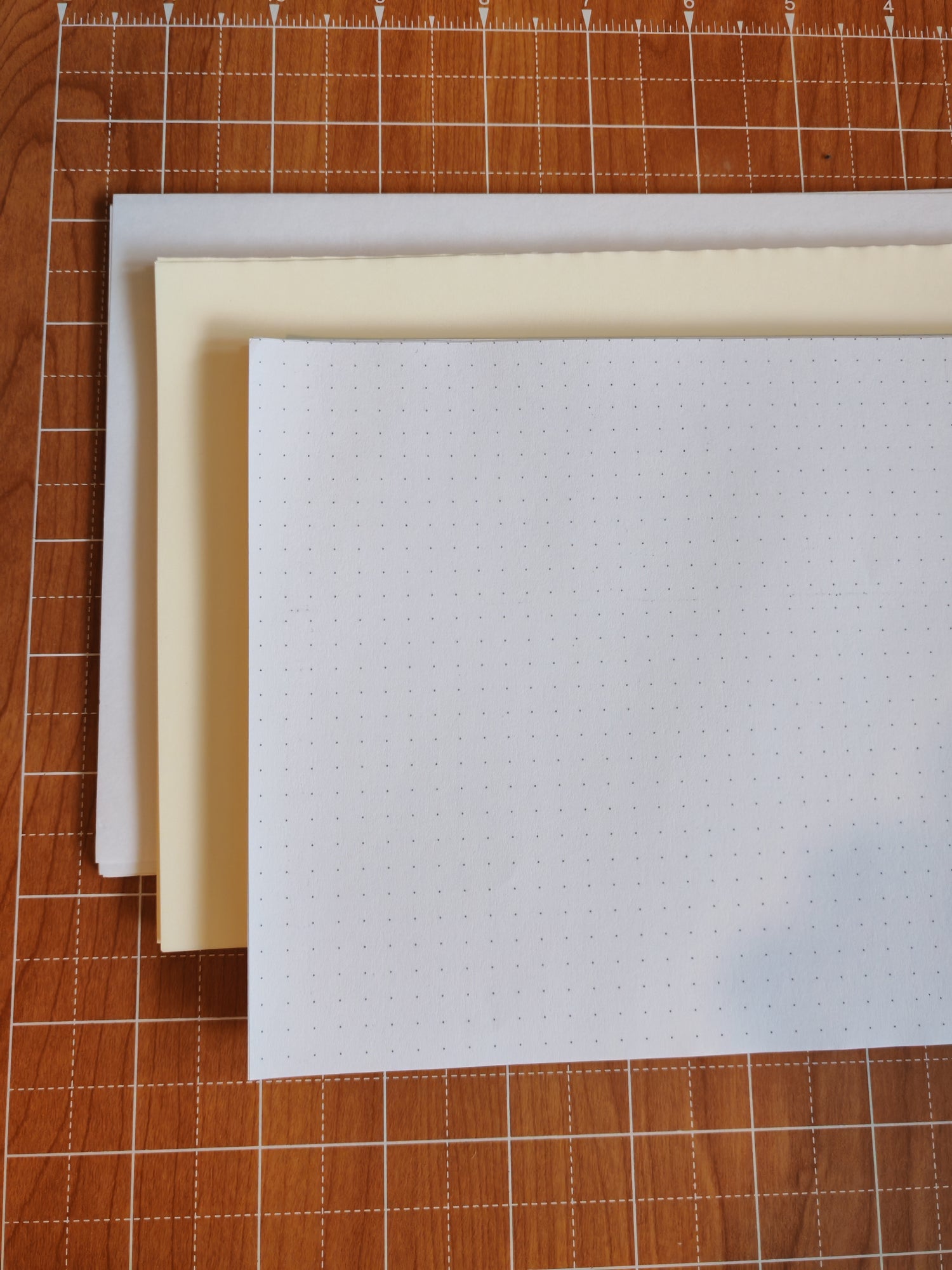 A selection of sheets of high quality paper, dot grid miquelrius paper, cream tomoe river paper and white clairefontaine paper