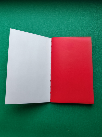 White page with a bight red vellum end page on a green background