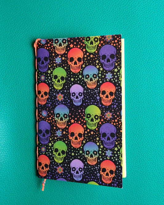 travelers notebook insert with colorful skull pattern on a teal background