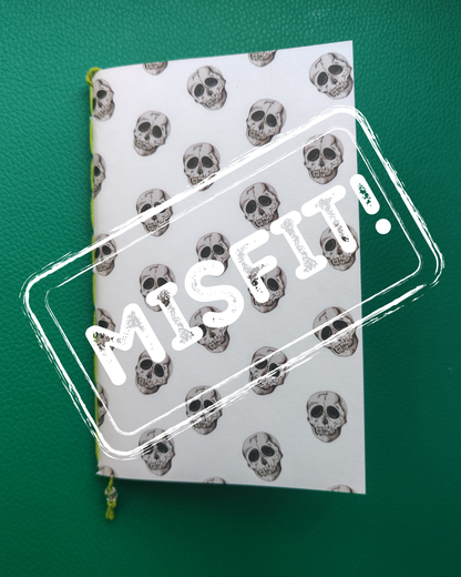 Notebook with skull pattern and 'MISFIT' text on a green background