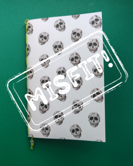 Notebook with skull pattern and 'MISFIT' text on a green background