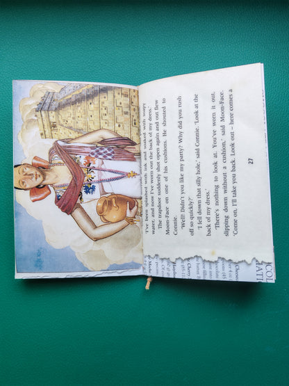 Open junk journal with illustrated page on a green background