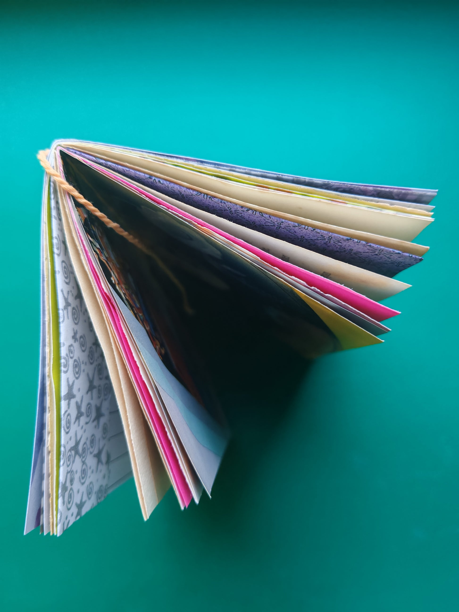Top view off open junk journal with colorful mixed media pages 