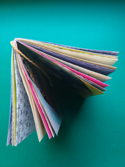Top view off open junk journal with colorful mixed media pages 