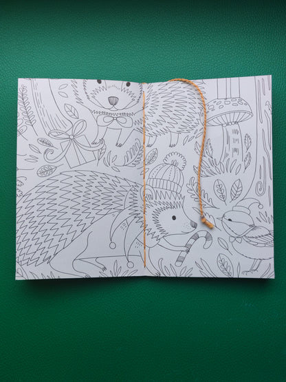 Open book with hedgehog illustrations on a green background