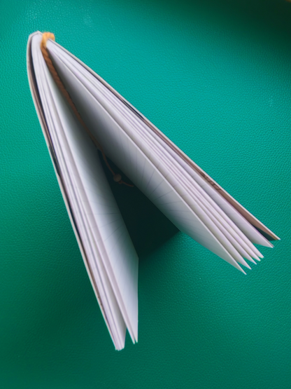 Notebook standing open on desk photographed from above