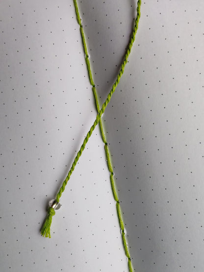 green thread bookmark with a clear glass bead