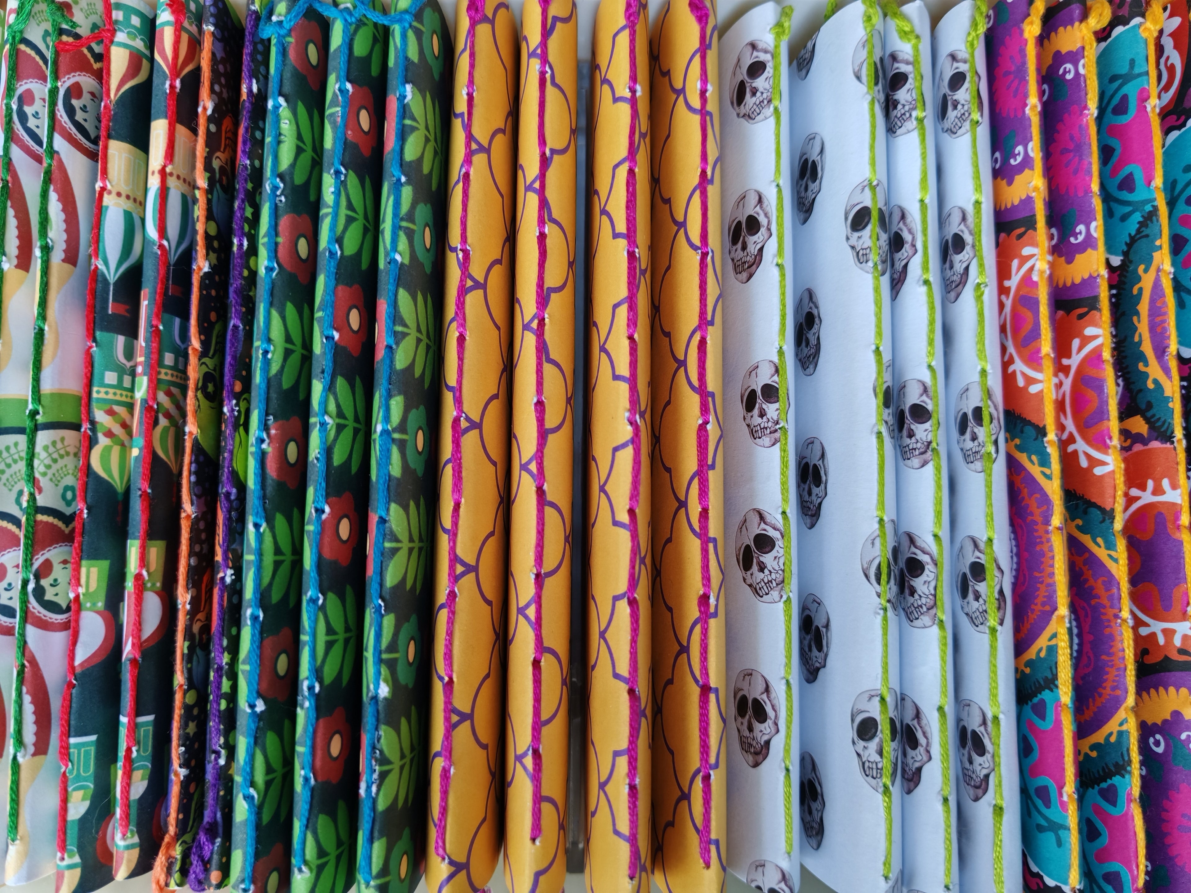 row of pocket sized notebooks in a variety of colours and patterns